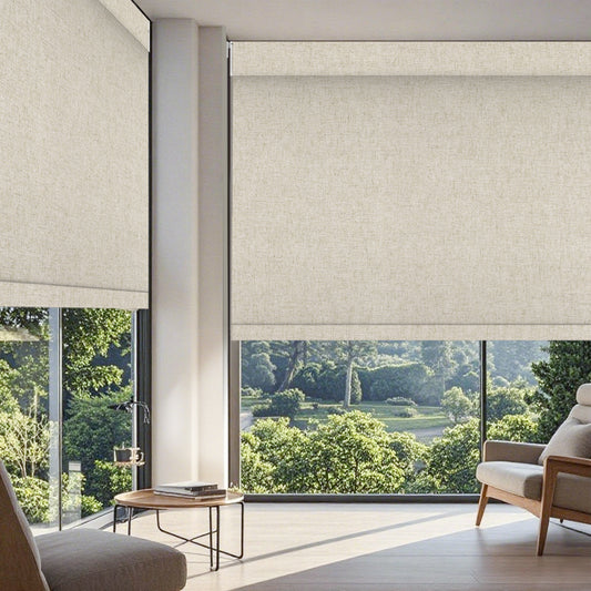 No drill motorized roller shades in a bright living room with beige sofa, wooden coffee table, decorative plants, and natural light coming through the windows